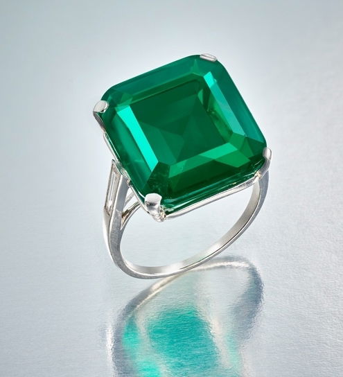 An exceptional emerald set in a platinum and baguette diamond